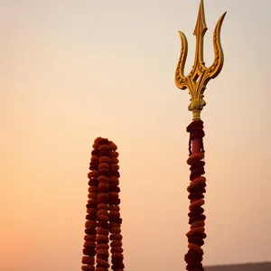 sacred weapon - good morning durga images with ornate golden trident with marigold garlands at sunrise — lovely good morning durga images HD pic